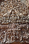 Banteay Srei temple - second enclosure, portico of the east gopura, a thick-breasted deity sits by two elephants with upraised trunks 